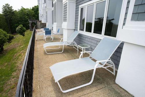 a group of chairs sitting on a balcony at Bluenose Inn - Bar Harbor Hotel in Bar Harbor