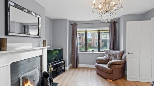 a living room with a fireplace and a chair and a mirror at Dun Na Caraige in Kingscourt