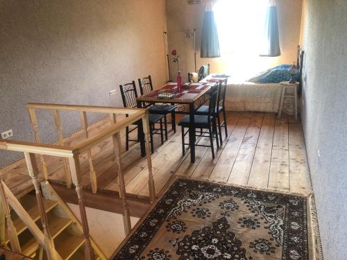 a dining room with a table and chairs in a room at Sweet Honey homestay in Jūrmala