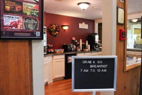a sign in front of a bar in a restaurant at Fireside Inn & Suites Gilford in Gilford