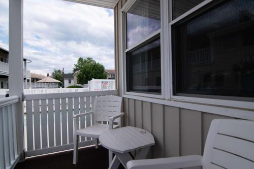 two chairs and a table on a porch at The Gull Oceanside Inn & Motel in Old Orchard Beach