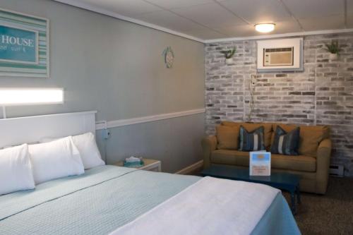 a hotel room with a bed and a couch at The Janmere Motel in Hampton