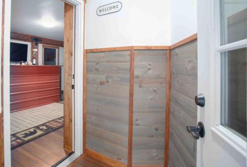 a door to a room with a wooden wall at Meadow Rue Retreat in Dennis Manor