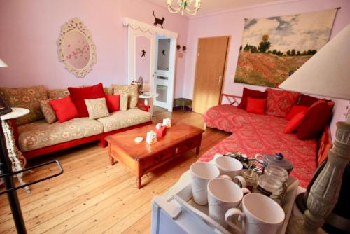 a living room with a couch and a table at Aggarthi Bed and Breakfast in Bayeux