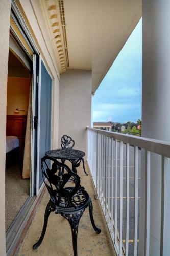 a table and chair on a balcony with a view at Senator Inn & Spa in Augusta
