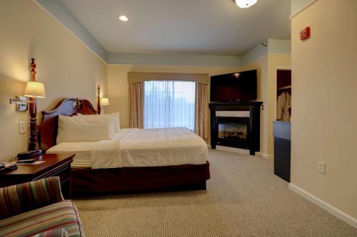 a hotel room with a bed and a fireplace at Senator Inn & Spa in Augusta