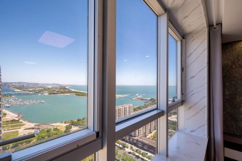 a view of the ocean from a building window at Cloud & Sea Boutique Apartment in Rizhao