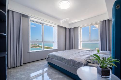 a bedroom with a bed and a table and windows at Cloud & Sea Boutique Apartment in Rizhao