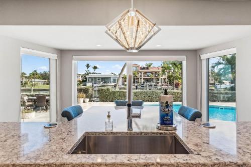 a kitchen sink with a view of a pool at Peaceful Haven Waterfront Home Tierra Verde in Tierra Verde