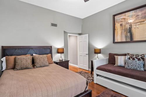 a bedroom with a bed and a couch at Peaceful Haven Waterfront Home Tierra Verde in Tierra Verde