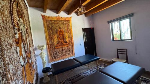 a room with a tapestry hanging on the wall at Hotel Quinta Mirador Zacualli in Bernal