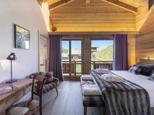 a bedroom with a bed and a couch and a window at Duplex Montagne Spacieux avec Cheminée, 4 Chambres - FR-1-570-21 in Praranger