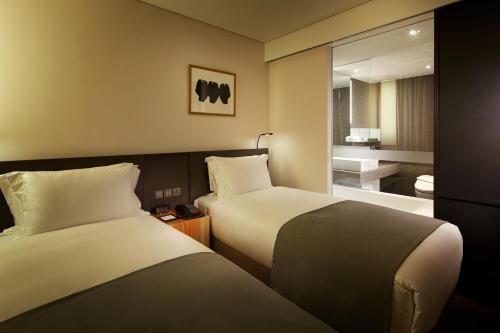 a hotel room with two beds and a bathroom at Shilla Stay Guro - Guro Digital Complex Station in Seoul