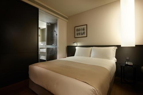 a bedroom with a large white bed and a window at Shilla Stay Guro - Guro Digital Complex Station in Seoul