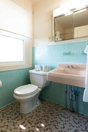 a bathroom with a toilet and a sink at Wonder View Inn in Bar Harbor