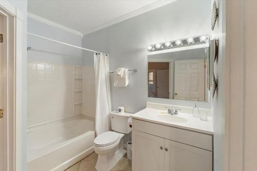 Un baño blanco con inodoro y lavabo. en Beachway One Bedroom Paradise Your Tranquil, en Redington Shores