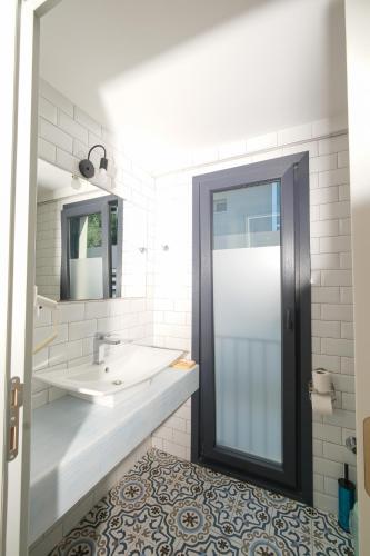 a bathroom with a sink and a mirror at Kybele Alaçatı in İzmir