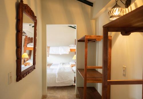 a bedroom with a mirror and a bunk bed at Hotel Beth Sarim in Villa de Leyva