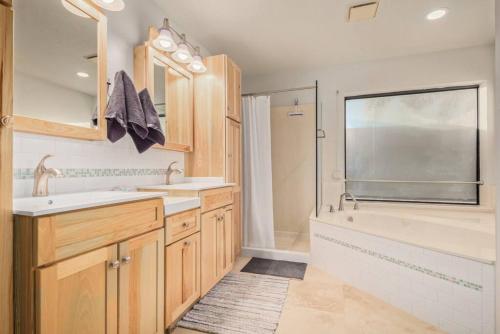 a bathroom with a tub and a sink and a shower at Sunrise Oasis your Western Oasis in the Desert in Fountain Hills