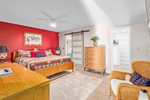 a bedroom with a bed and a red wall at Vibrant 4 Bedroom with Pool and Spa in Fountain Hills