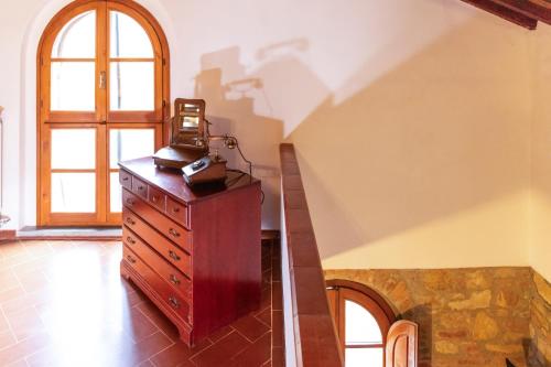 a room with a dresser with a telephone on top of it at Borgo Il Poggio Agriturismo in Montaione