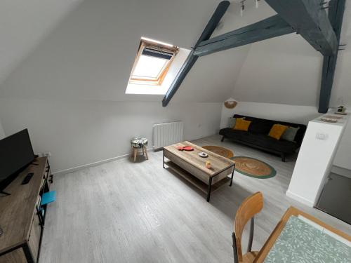 a living room with a table and a couch at Appartement avec cours in Saint-Brisson-sur-Loire