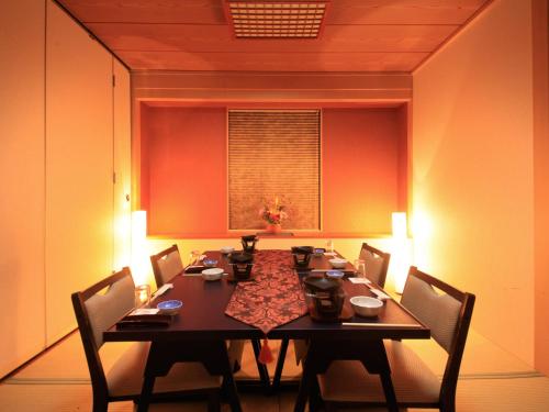 a dining room with a long table and chairs at Hotel Tsubakino in Yamanouchi