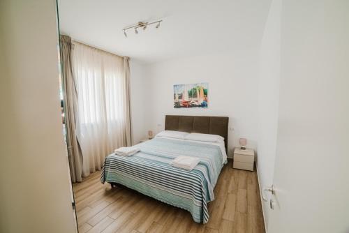 a bedroom with a bed in a white room at Villa Capri in Campofelice di Roccella