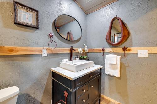 a bathroom with a sink and two mirrors on the wall at Walk to Grand Lake Pet-Friendly Grove Getaway! in Grove