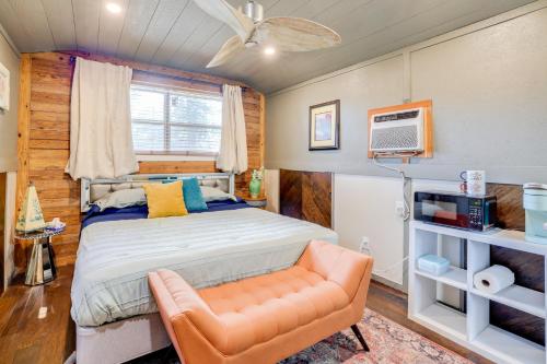 a bedroom with a bed and a couch and a tv at Pet-Friendly Grand Lake Studio with Outdoor Space in Grove