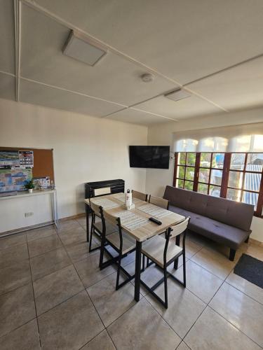 a living room with a table and a couch at El Condor Fueguino II in Ushuaia