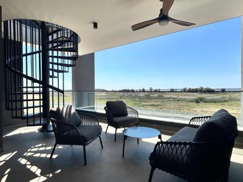 a waiting room with chairs and a large window at Sunset Gardens - Holiday Apartments - by TLV Living in Limassol
