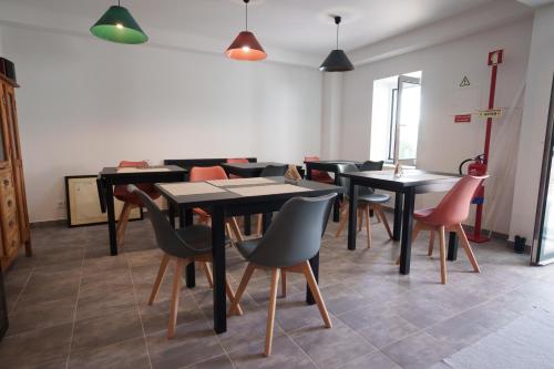 a dining room with tables and chairs at The Plantation Faial in Feteira