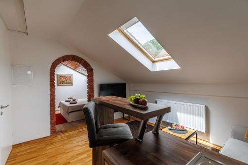 a living room with a table and a skylight at UrbanStudio5 in Čakovec