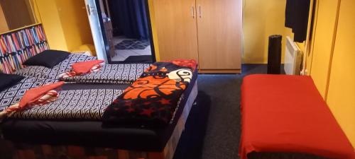 a room with a bed and a couch and a table at Táltos Vendégház in Szilvásvárad