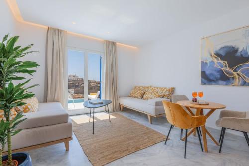 a living room with a couch and a table at San Antonio Summerland in Mýkonos City