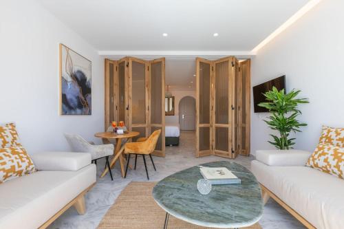 a living room with a couch and a table at San Antonio Summerland in Mýkonos City