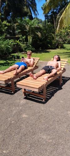 two men laying on picnic tables in a park at The Esence of Sri Lanka in Ahungalla