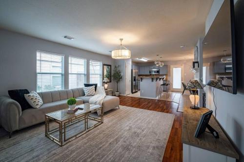 a living room with a couch and a table at Cozy 3 bedrooms House - Feel Like Home in Houston
