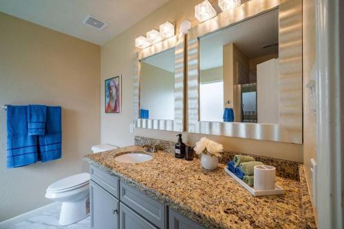 a bathroom with a sink and a toilet and a mirror at Cozy 3 bedrooms House - Feel Like Home in Houston