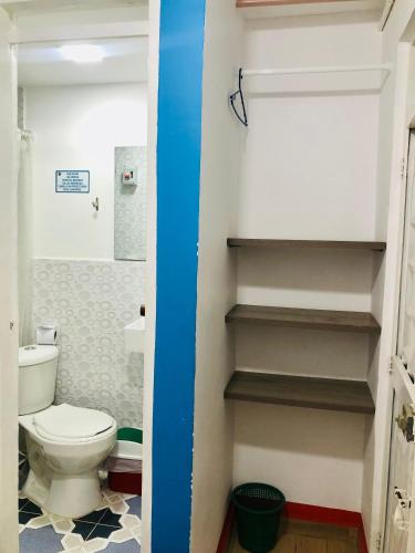 a bathroom with a toilet and stairs in it at Hotel Café Color in Armenia