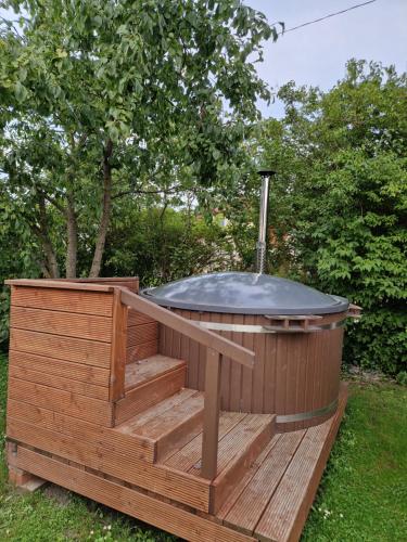 a hot tub sitting on top of a wooden deck at Namiņš ar balkonu in Jelgava