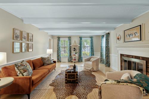 a living room with a couch and a fireplace at Cozy 4bd Home - NC State & Airport nearby in Cary