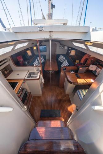 a view of the inside of a boat with benches at Sleep and Sail - Marina de Oeiras - Lisbon's coast in Oeiras