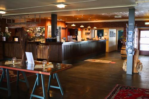 a restaurant with a wooden table and a bar at Rauland Høgfjellshotell in Rauland