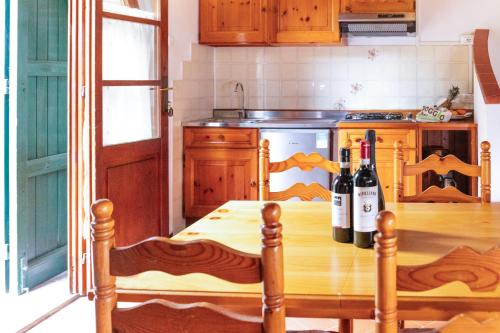 a kitchen with a table with two bottles of wine at Borgo Il Poggio Agriturismo in Montaione