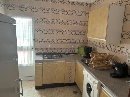 a kitchen with a sink and a stove top oven at Pisos Isla Cristina 1 in Isla Cristina