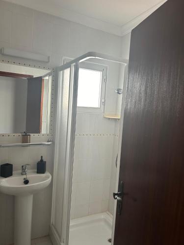 a bathroom with a sink and a toilet and a shower at Pisos Isla Cristina 1 in Isla Cristina