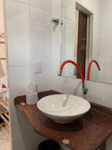 a white sink on a counter in a bathroom at Suites Casa De Ban in Lençóis