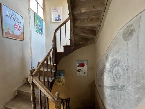 a staircase in a house with a wooden stair case at Le 19 - Chambre Patio 34m2 - Centre Historique - Clim in Langeac
